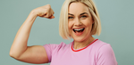 blonde middle aged woman in pink shirt showing off her muscles