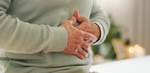 Elderly man holding his gut