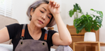 Middle-aged Asian woman in overalls overwhelmed in the summertime