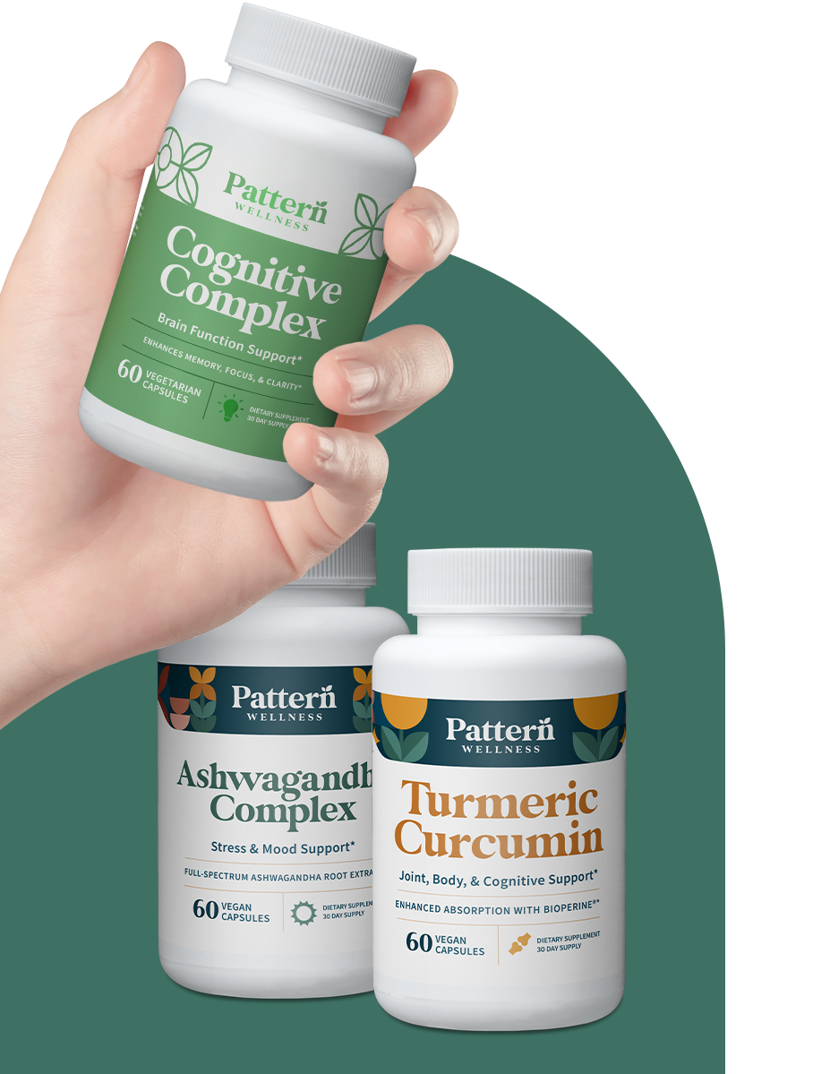 Bottles of the Cognitive Health Bundle. A hand is holding the Cognitive Complex bottle.
