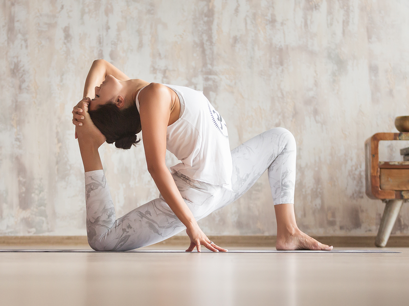 A woman demonstrating a yoga pose.