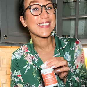 A customer is flexing a bottle of Pattern Wellness Zinc Complex.