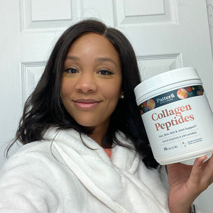 A female customer with a bright smile holding a jar of Pattern Wellness Collagen Peptides Powder.