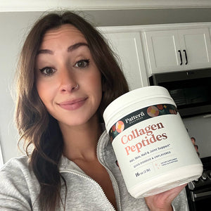 A female customer smiling while holding a jar of Pattern Wellness Collagen Peptides Powder.