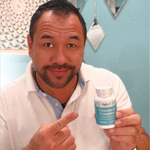 A male customer proudly showcasing a bottle of Pattern Wellness Vitamin B Complex.