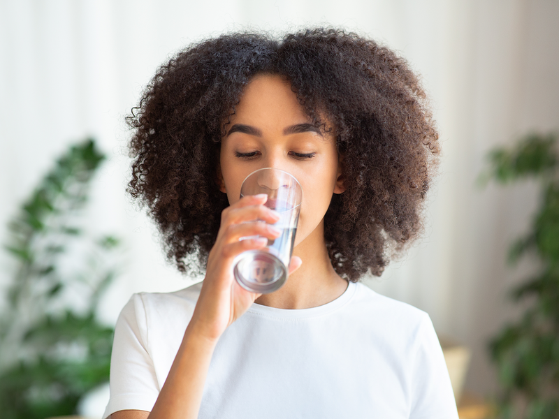 A young person drinking water.