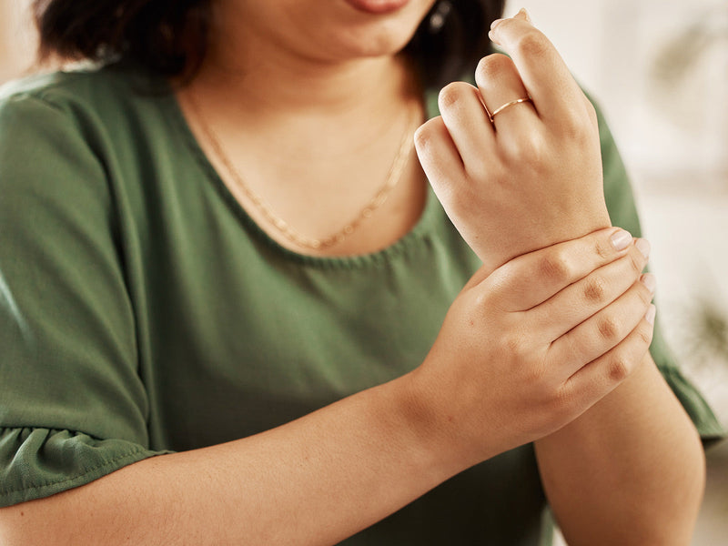 A woman with a visibly injured wrist.