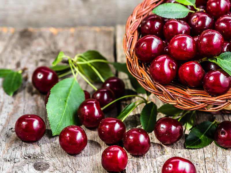 A basket filled with fresh cherries.