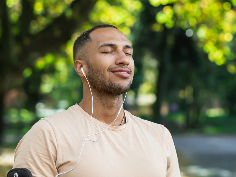 A man is relaxing after jogging.