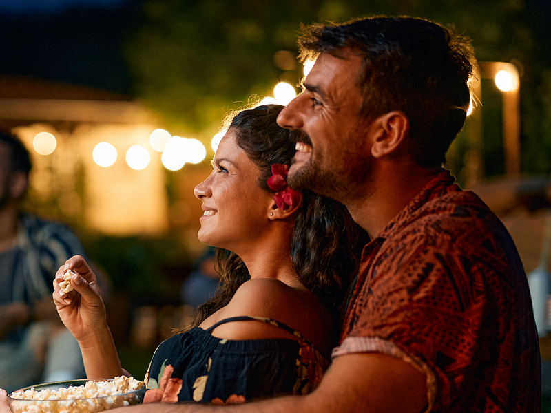 Man and women enjoying popcorn.